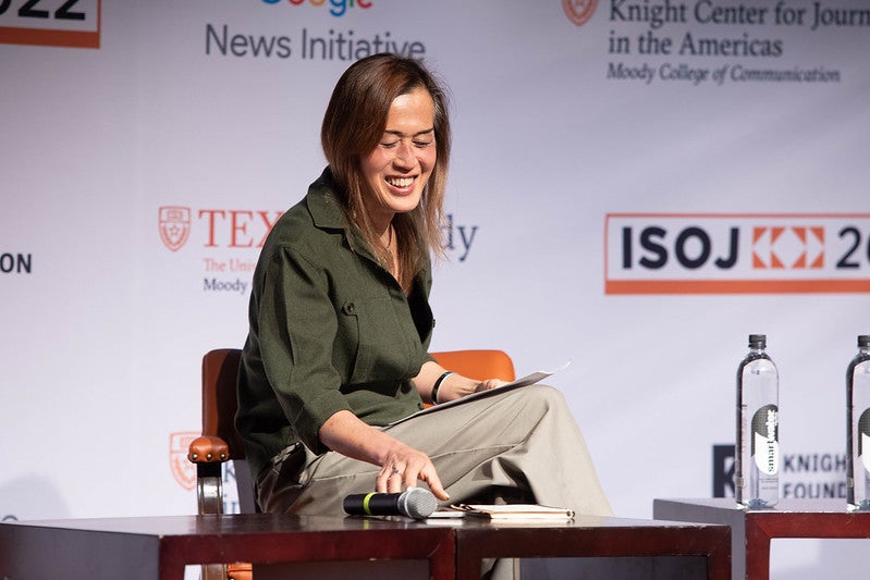 woman in green shirt smiling