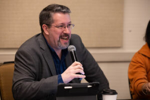 Damon Kiesow enjoys a laugh during breakfast panel at 25th ISOJ.