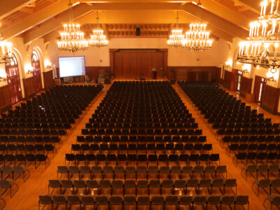 Ballroom with hanging chandeliers and woodwork