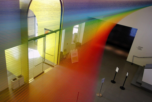 A rainbow streams through a museum room